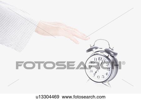 Hand reaching for alarm clock View Large Photo Image Stock Photo - Hand reaching for alarm clock. Fotosearch