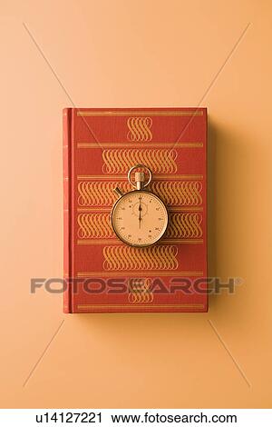 Stock Image - Stopwatch on book. Fotosearch