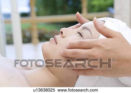 Stock Photography - Young woman getting a facial massage, Saipan. Fotosearch