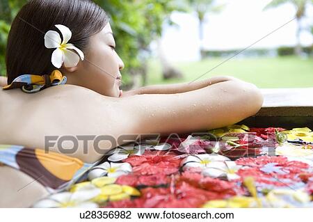 Young woman in a bath full of flowers, Saipan, Rear View View Large Photo Image Stock Image - Young woman in a bath full of flowers, Saipan, Rear View. Fotosearch