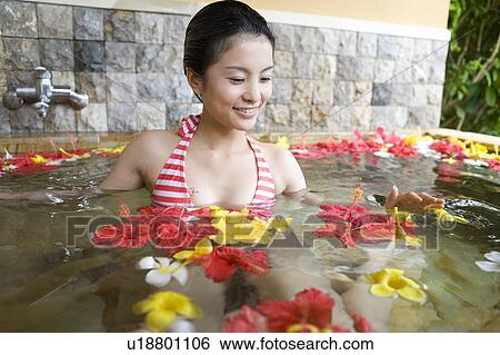 Young woman in a bath full of flowers, Saipan View Large Photo Image Stock Photograph - Young woman in a bath full of flowers, Saipan. Fotosearch