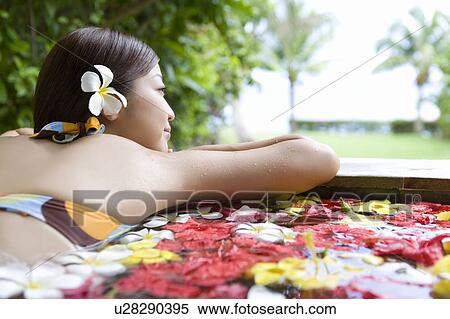 Young woman in a bath full of flowers, Saipan, Rear View View Large Photo Image Stock Photography - Young woman in a bath full of flowers, Saipan, Rear View. Fotosearch
