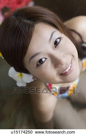 Stock Image - Young woman in a bikini looking up, Saipan. Fotosearch
