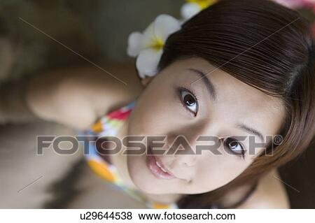Stock Photo - Young woman in a bikini looking up, Saipan. Fotosearch