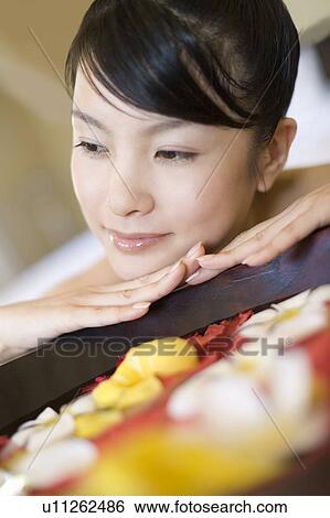 Young woman looking at footbath with flowers, Saipan, Focus on Foreground View Large Photo Image Stock Photograph - Young woman looking at footbath with flowers, Saipan, Focus on Foreground. Fotosearch