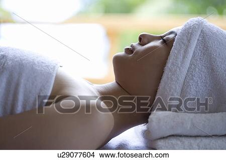 Picture - Young woman lying on a massage table . Fotosearch