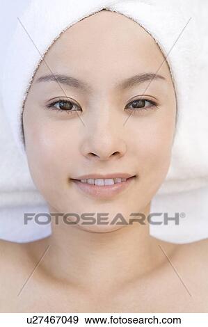 Stock Photo - Young woman with towel wrapped around her head, Saipan. Fotosearch