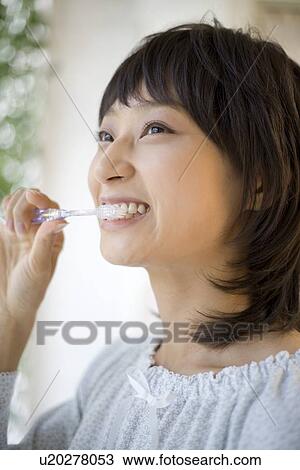 Housewife brushing her teeth View Large Photo Image Stock Image - Housewife brushing her teeth. Fotosearch