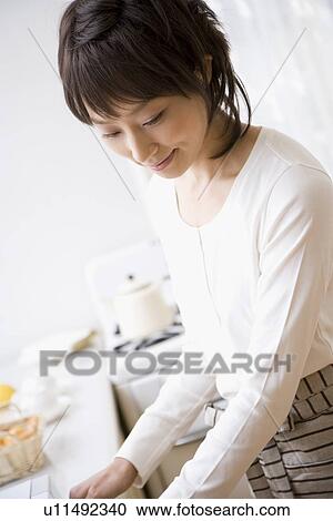 Housewife cooking in kitchen View Large Photo Image Stock Image - Housewife cooking in kitchen. Fotosearch