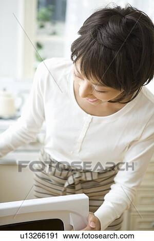 Housewife cooking in kitchen View Large Photo Image Stock Image - Housewife cooking in kitchen. Fotosearch