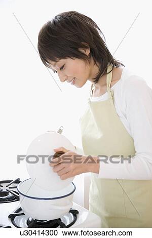 Housewife cooking in kitchen View Large Photo Image Stock Image - Housewife cooking in kitchen. Fotosearch