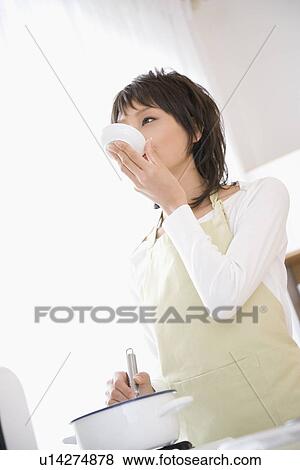 Stock Photo - Housewife cooking in kitchen. Fotosearch