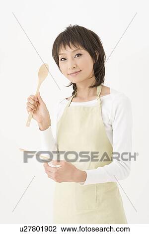 Stock Image - Housewife holding bowl. Fotosearch