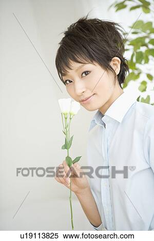 Stock Photography - Housewife holding flower. Fotosearch