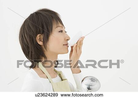 Stock Photo - Housewife holding ladle and tasting. Fotosearch