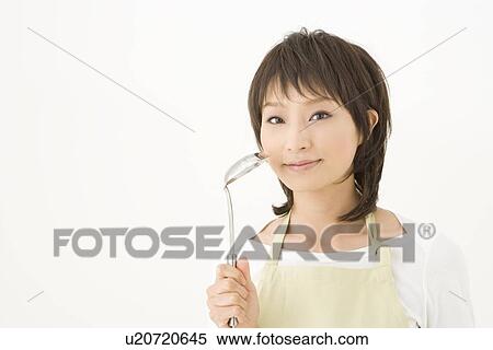 Stock Photography - Housewife holding ladle. Fotosearch