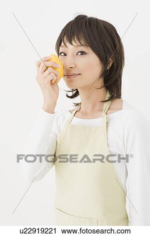 Stock Image - Housewife holding lemon. Fotosearch