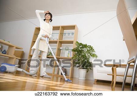 Housewife vacuuming room View Large Photo Image Stock Image - Housewife vacuuming room. Fotosearch