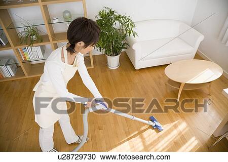 Housewife vacuuming room View Large Photo Image Stock Image - Housewife vacuuming room. Fotosearch