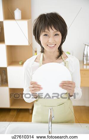Housewife washing dishes View Large Photo Image Picture - Housewife washing dishes. Fotosearch