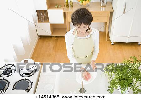 Housewife washing dishes View Large Photo Image Stock Photography - Housewife washing dishes. Fotosearch