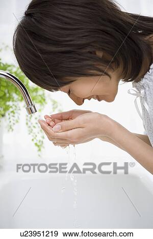 Housewife washing her face View Large Photo Image Stock Photo - Housewife washing her face. Fotosearch