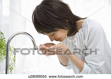 Housewife washing her face View Large Photo Image Stock Photography - Housewife washing her face. Fotosearch