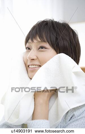 Housewife wiping face with towel View Large Photo Image Stock Image - Housewife wiping face with towel. Fotosearch