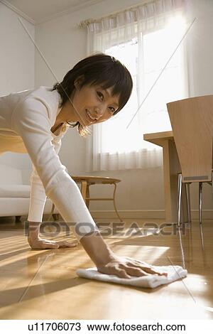 Stock Image - Housewife wiping floor. Fotosearch
