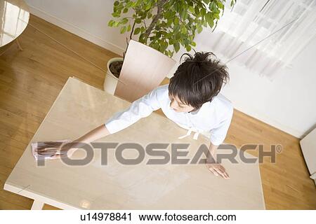 Housewife wiping table View Large Photo Image Stock Image - Housewife wiping table. Fotosearch