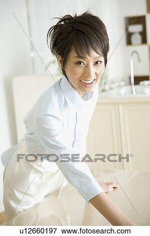 Stock Photo - Housewife wiping table. Fotosearch