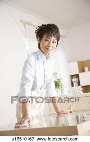 Housewife wiping table View Large Photo Image Stock Photo - Housewife wiping table. Fotosearch