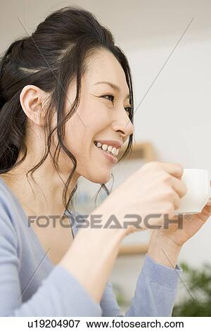 Young woman drinking coffee View Large Photo Image Stock Photo - Young woman drinking coffee. Fotosearch