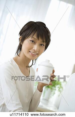 Young woman holding jar View Large Photo Image Stock Image - Young woman holding jar. Fotosearch