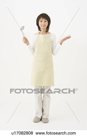 Young woman holding ladle View Large Photo Image Stock Photo - Young woman holding ladle. Fotosearch