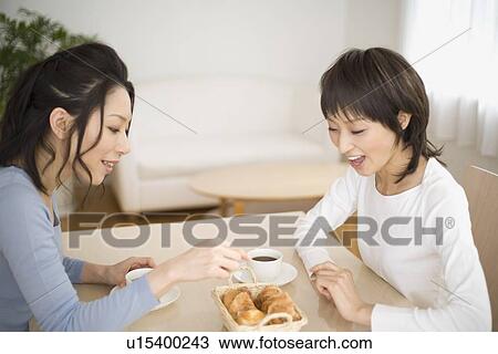 Young women eating dessert View Large Photo Image Stock Image - Young women eating dessert. Fotosearch