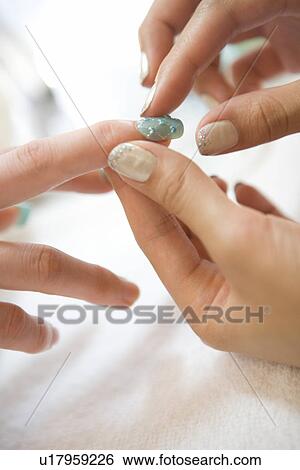 Beautician applying artificial nail View Large Photo Image Stock Photograph - Beautician applying artificial nail. Fotosearch