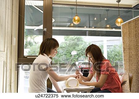 Stock Photography - Beautician filing nails. Fotosearch