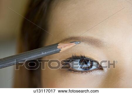 Young woman applying make up View Large Photo Image Stock Photo - Young woman applying make up. Fotosearch