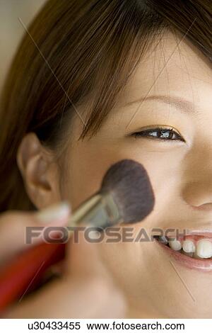 Young woman applying make up View Large Photo Image Stock Photography - Young woman applying make up. Fotosearch