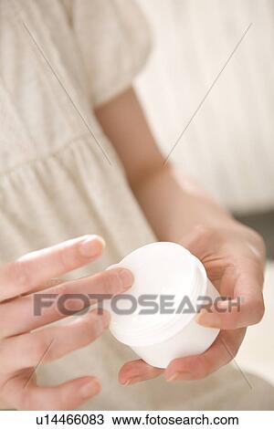 Young woman applying moisturizer View Large Photo Image Stock Image - Young woman applying moisturizer. Fotosearch