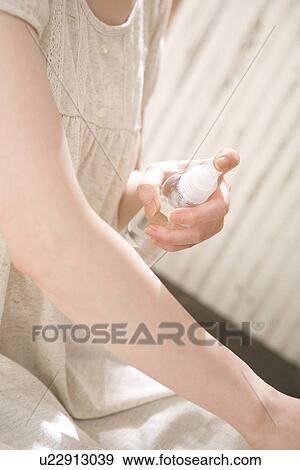 Young woman applying moisturizer View Large Photo Image Stock Photo - Young woman applying moisturizer. Fotosearch