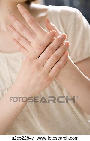 Young woman applying moisturizer View Large Photo Image Stock Photo - Young woman applying moisturizer. Fotosearch