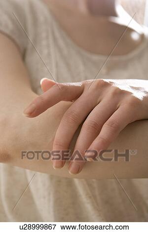 Young woman applying moisturizer View Large Photo Image Stock Photo - Young woman applying moisturizer. Fotosearch