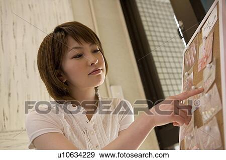 Young woman choosing at nail salon View Large Photo Image Stock Photo - Young woman choosing at nail salon. Fotosearch