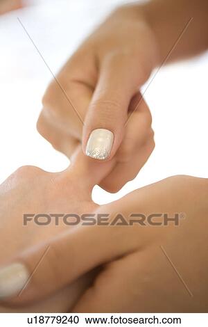 Young woman massaging fingers View Large Photo Image Stock Image - Young woman massaging fingers. Fotosearch