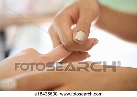 Young woman massaging fingers View Large Photo Image Stock Photo - Young woman massaging fingers. Fotosearch