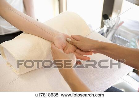 Stock Photography - Young woman massaging hands. Fotosearch