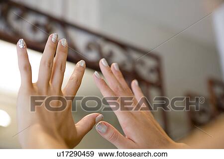 Stock Photo - Young woman showing manicure. Fotosearch