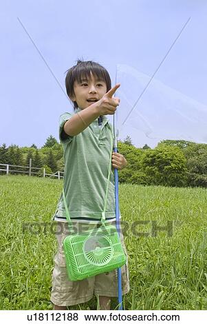Stock Photo - Boy catching insect. Fotosearch